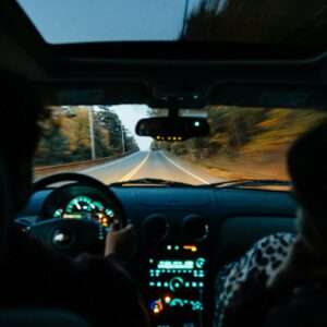 a person driving a car on a road at night